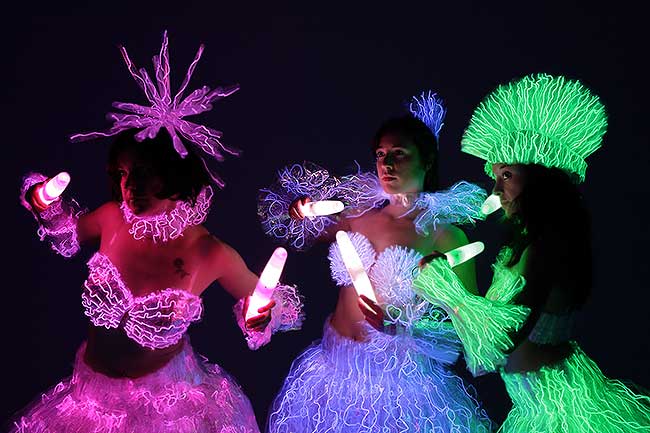 Art performance with LED lights and glowing costumes